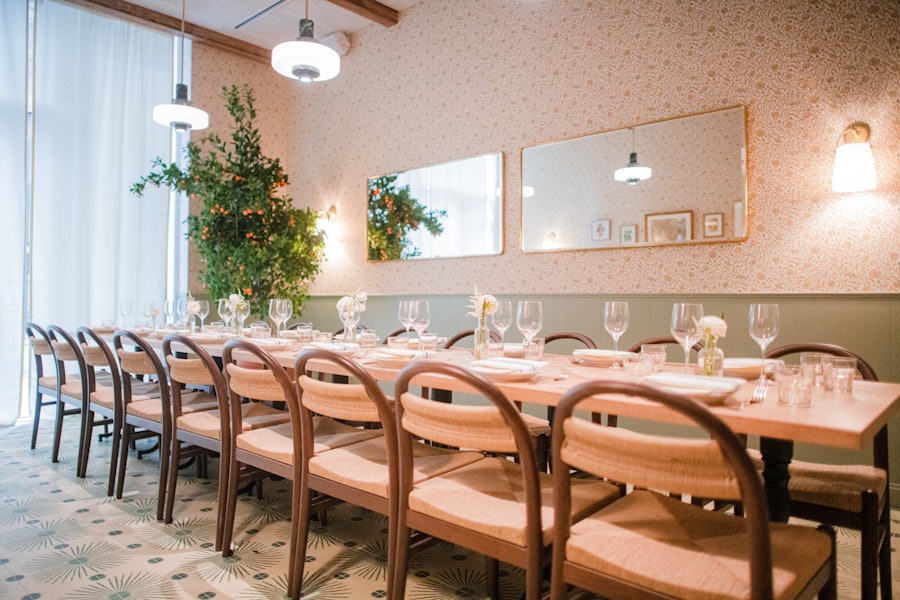 The private dining room at Rosemary's Midtown set up with one long table in the middle of the room.