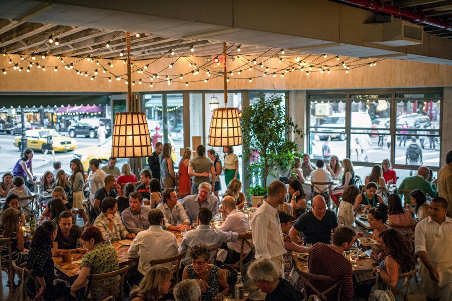 The dining room at Rosemary's during service, with many people seated at various tables.
