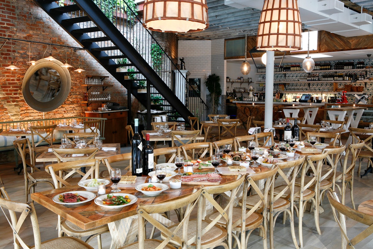 The communal table in the center of the Rosemary's dining room set for large party service.