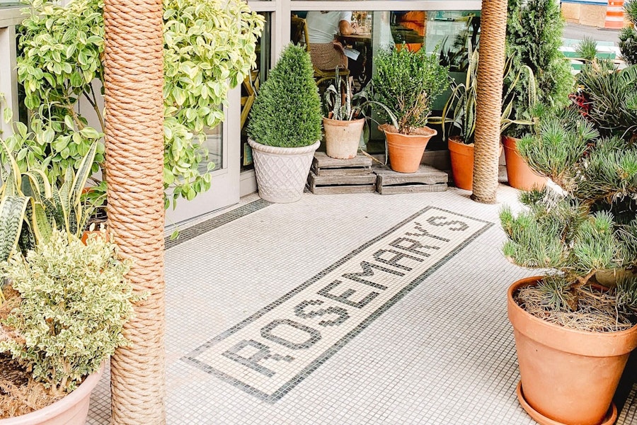 The entryway to Rosemary's featuring the restaurant's name spelled out in green tiles on a white tiled background.